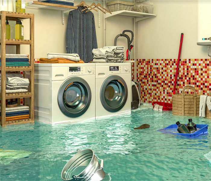 a flooded laundry room with water covering the floor