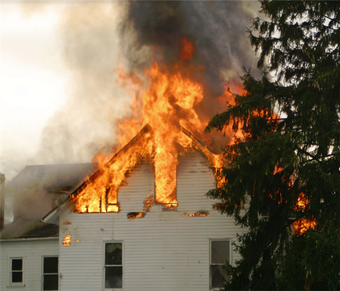 a house with the top floor on fire