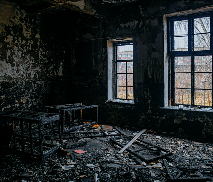 a fire damaged room with soot and debris everywhere