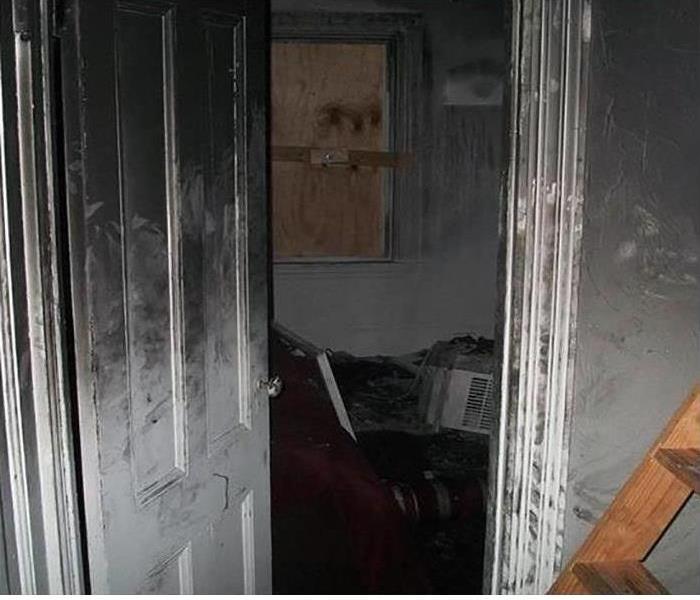 A room covered in soot and smoke damage after a fire